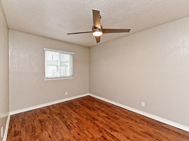 spare room featuring ceiling fan, baseboards, a textured ceiling, and wood finished floors