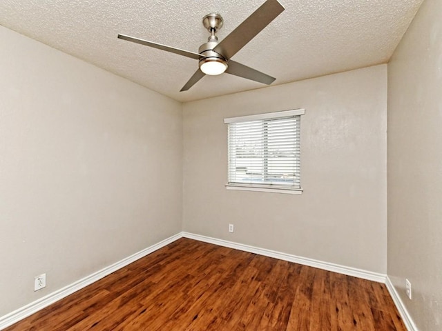 empty room featuring baseboards, a textured ceiling, wood finished floors, and a ceiling fan