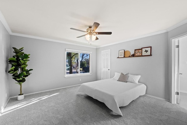 carpeted bedroom with ceiling fan, baseboards, and ornamental molding