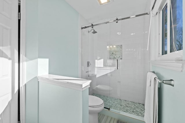 full bathroom with a shower stall, toilet, and visible vents