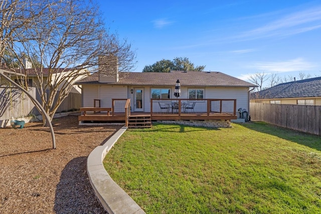 back of property featuring a deck, a lawn, a chimney, and a fenced backyard