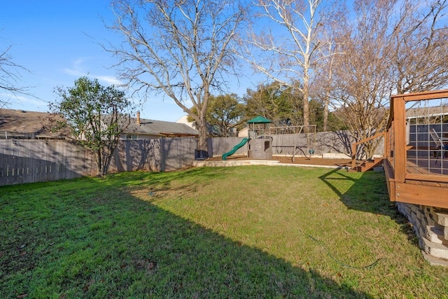 view of yard with a fenced backyard and a playground