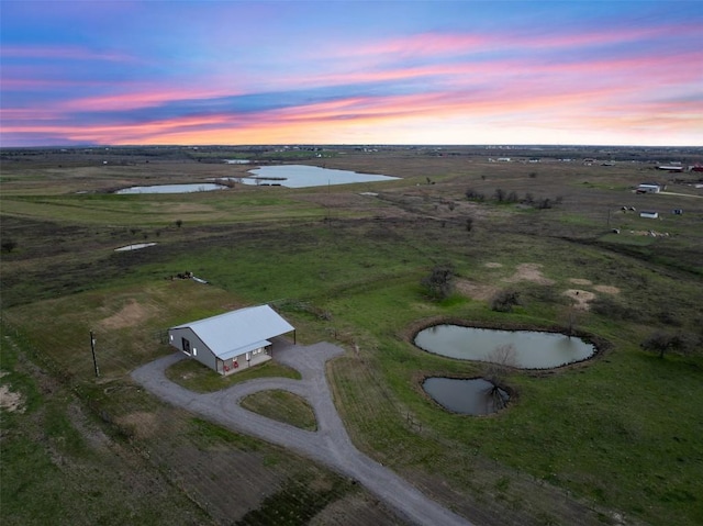 drone / aerial view with a rural view and a water view