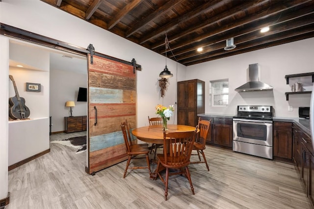 700 County Road 466, Elgin, TX 78621 - dining space with a barn door, wood ceiling with exposed beams, light wood-style flooring, and baseboards