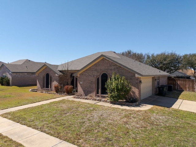 4201 Capri Dr, Killeen, TX 76549 - ranch-style house with brick siding, an attached garage, driveway, and a shingled roof