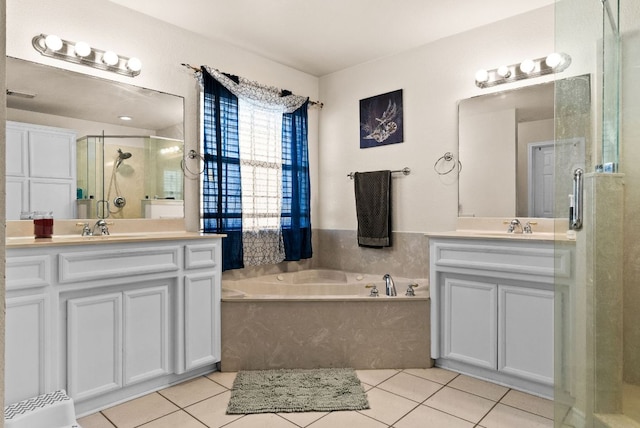 full bathroom featuring tile patterned floors, a stall shower, a bath, and two vanities