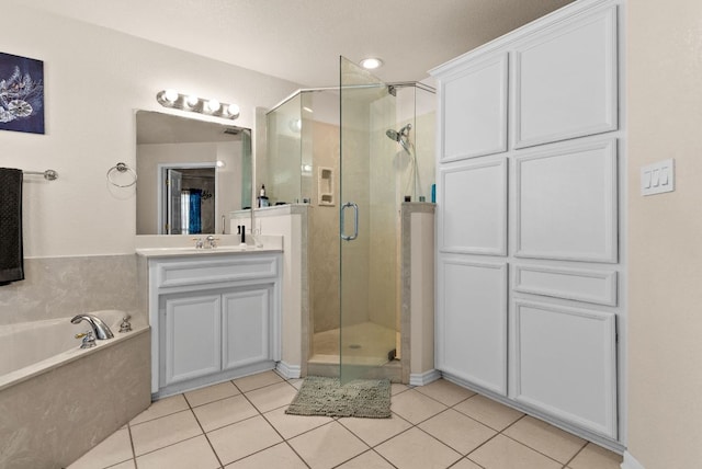 4201 Capri Dr, Killeen, TX 76549 - bathroom featuring a shower stall, a garden tub, tile patterned flooring, and vanity