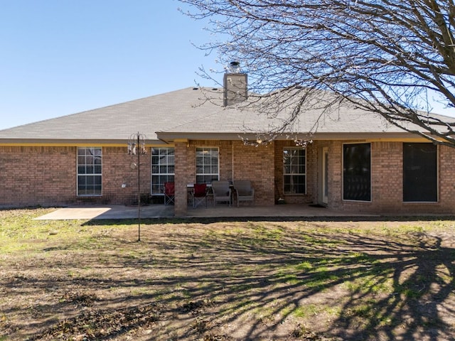 4201 Capri Dr, Killeen, TX 76549 - back of property with a patio, a chimney, and brick siding