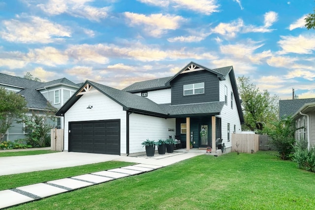 view of front of home featuring a front lawn, fence, roof with shingles, concrete driveway, and an attached garage