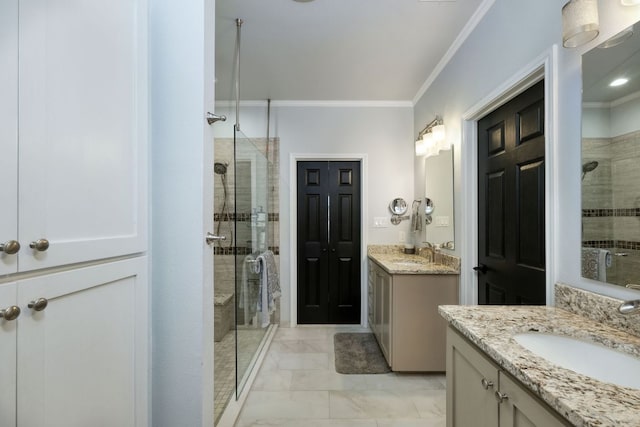 full bath with a sink, a stall shower, and crown molding