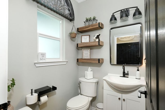 bathroom featuring toilet and vanity