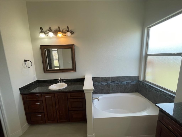 full bathroom with vanity and a bath