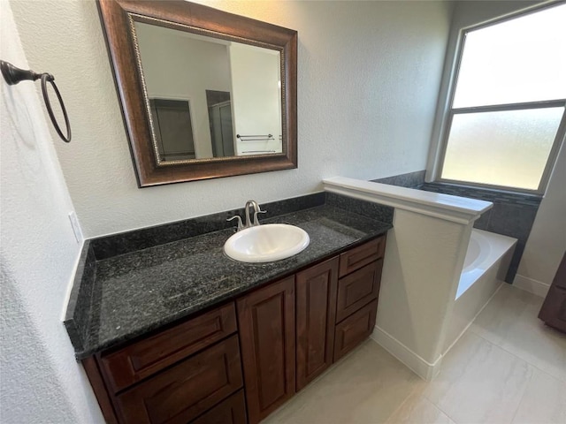 108 E Tanglebriar Ct, Bastrop, TX 78602 - bathroom featuring vanity, a garden tub, and a shower with shower door