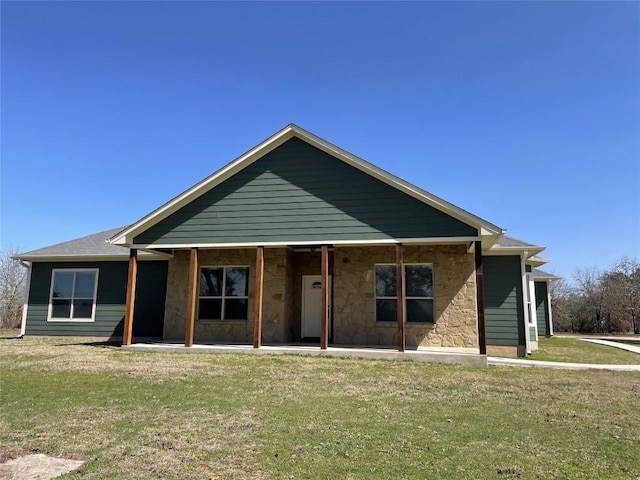 view of front of home featuring a front yard and stone siding