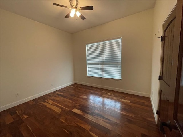 unfurnished room with baseboards, dark wood-type flooring, and a ceiling fan