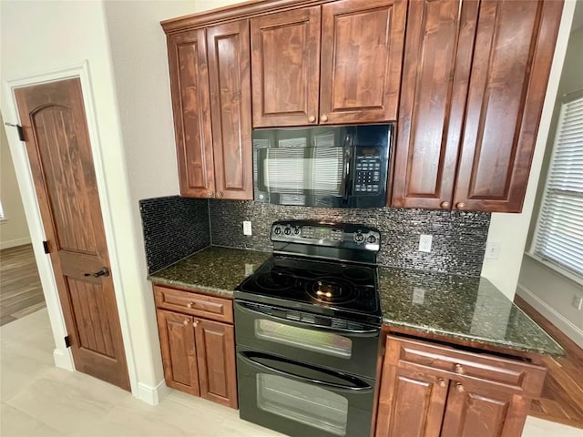 kitchen featuring decorative backsplash, black appliances, dark stone countertops, and baseboards