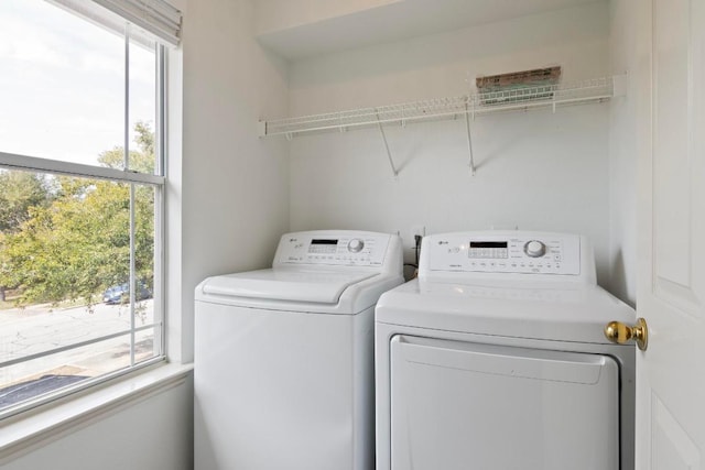 washroom with separate washer and dryer and laundry area