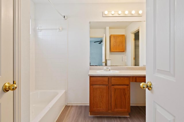 bathroom with vanity, bathtub / shower combination, and wood finished floors