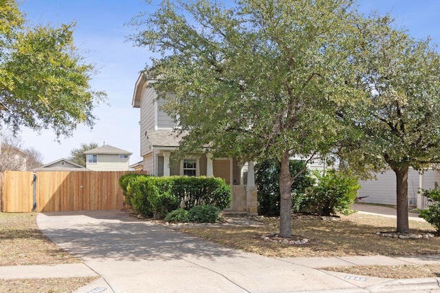 view of property hidden behind natural elements featuring fence