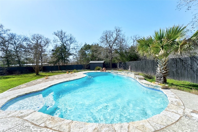 view of pool with an outbuilding, a fenced backyard, and a fenced in pool