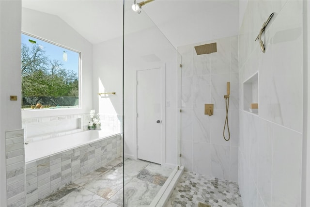 full bath with a bath, marble finish floor, a walk in shower, and lofted ceiling