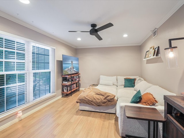 living area with ceiling fan, wood finished floors, baseboards, and ornamental molding