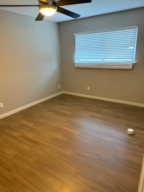 900 S Lamar Blvd Unit 205, Austin, TX 78704 - unfurnished room featuring ceiling fan, wood finished floors, and baseboards