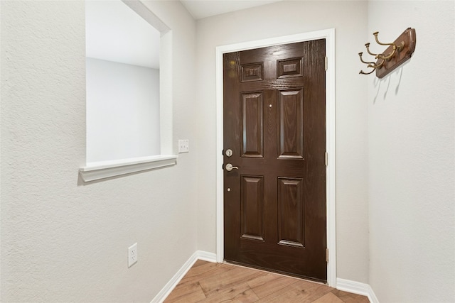 interior space featuring baseboards and light wood-style floors