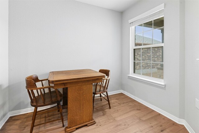 dining room featuring light wood-type flooring and baseboards