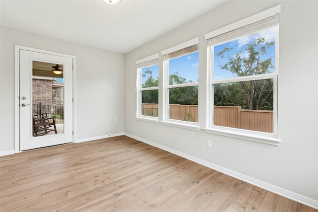 spare room featuring baseboards and light wood-style flooring