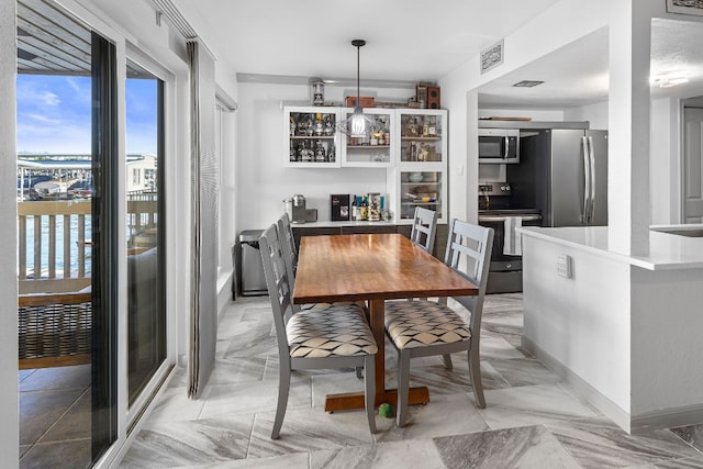 dining room featuring visible vents and baseboards