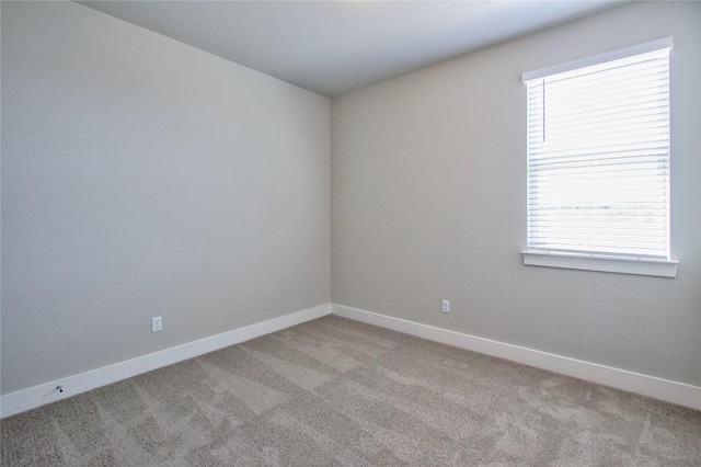 empty room with light colored carpet and baseboards