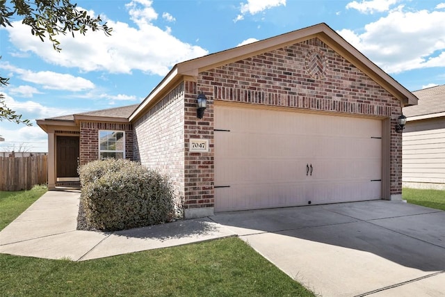 view of property exterior featuring brick siding, an attached garage, driveway, and fence