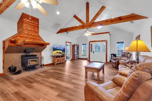 living area featuring a ceiling fan, wood finished floors, baseboards, high vaulted ceiling, and beam ceiling