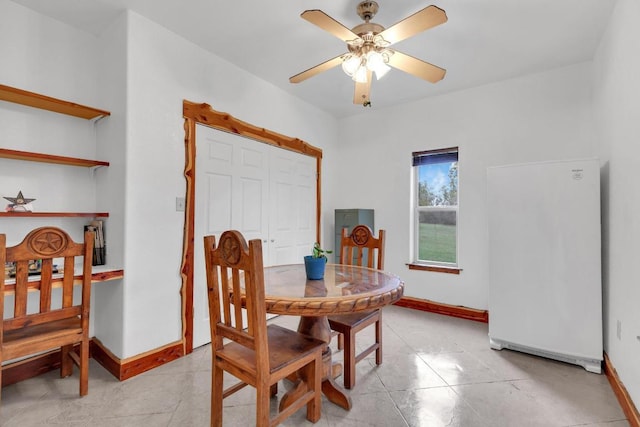 dining area featuring light tile patterned flooring, ceiling fan, and baseboards