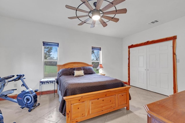 bedroom with light tile patterned floors, visible vents, and ceiling fan