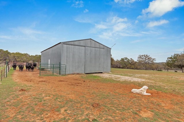 view of pole building featuring a yard and fence