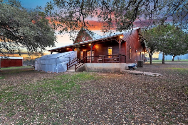 view of front of property featuring central AC and metal roof