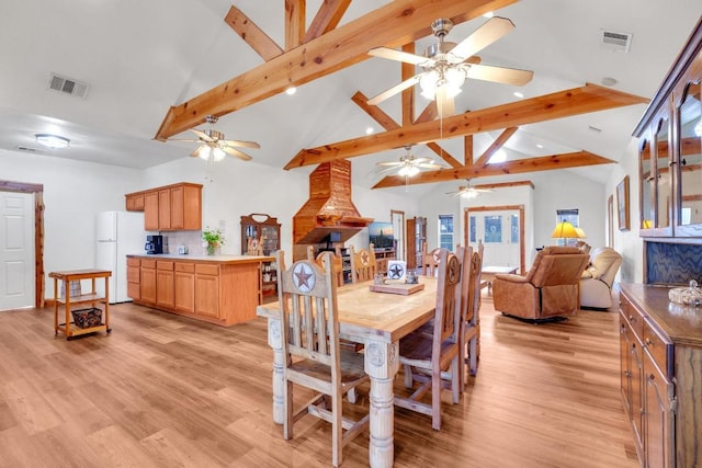 dining room with beam ceiling, visible vents, and light wood-type flooring