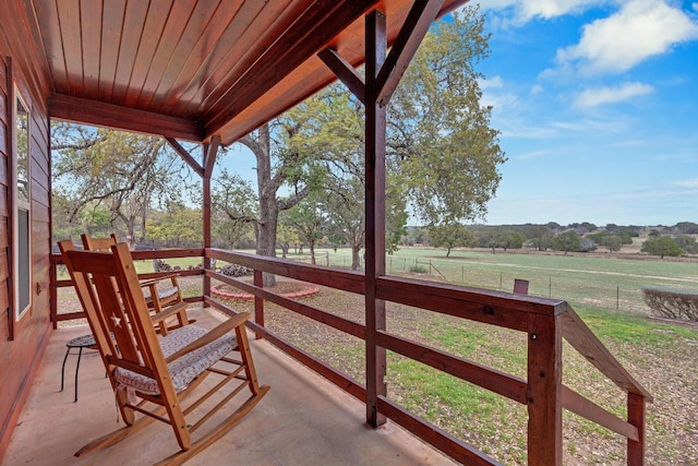 exterior space with a rural view, a lawn, and fence