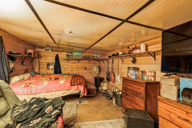 bedroom featuring wooden walls, concrete floors, and wooden ceiling