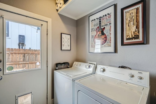 clothes washing area featuring a wealth of natural light, separate washer and dryer, and laundry area