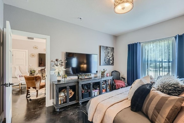 bedroom with visible vents and concrete flooring