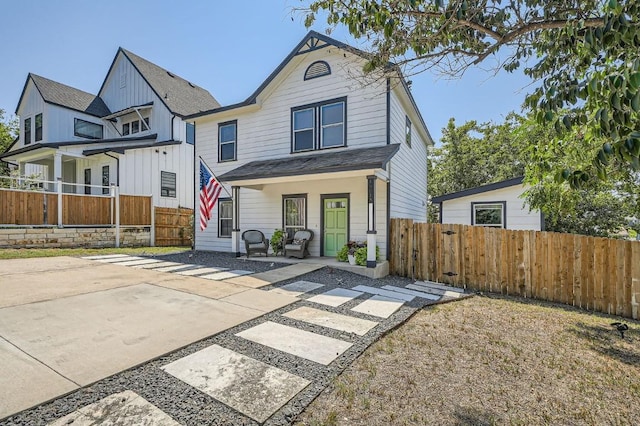 rear view of house featuring fence