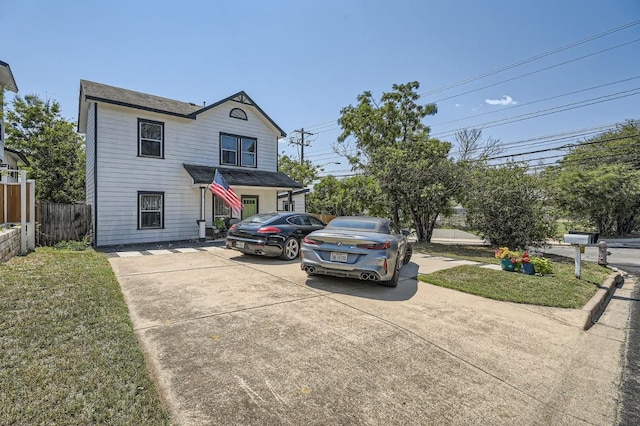 traditional-style home featuring fence