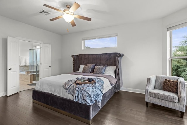 bedroom with a ceiling fan, wood finished floors, visible vents, baseboards, and ensuite bath