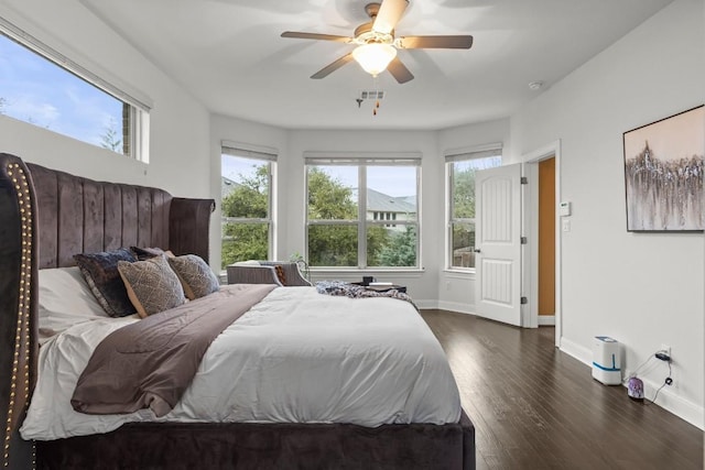 bedroom with visible vents, dark wood-style floors, baseboards, and ceiling fan