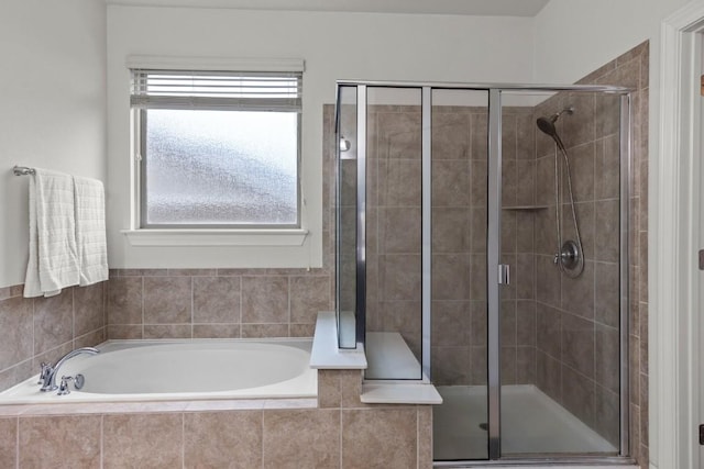 full bath featuring a shower stall and a garden tub