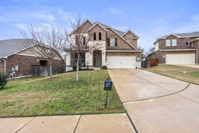 view of front of property with a front yard, fence, brick siding, and driveway