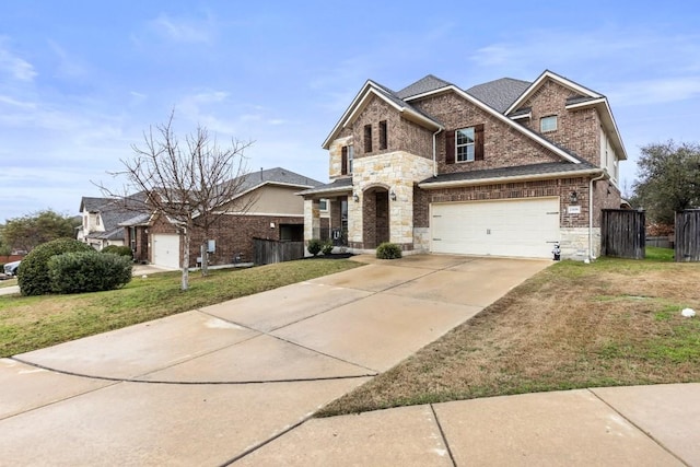 view of front facade featuring a front yard, brick siding, an attached garage, and driveway